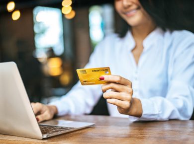 mujer alegre utilizando su tarjeta de crédito